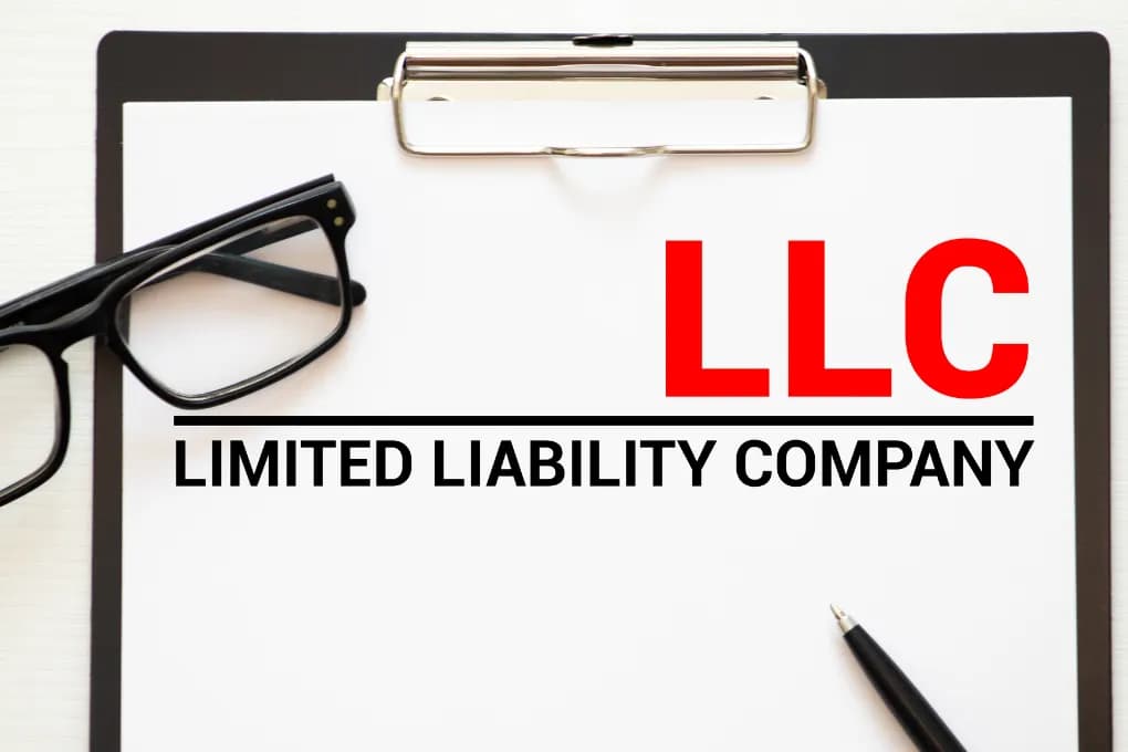 Graphic with limited liability company text and glasses on a table