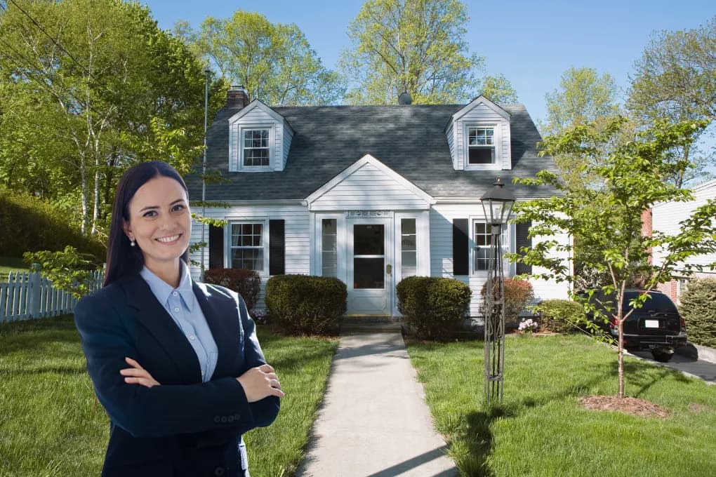 image of young real estate investor in front of a house