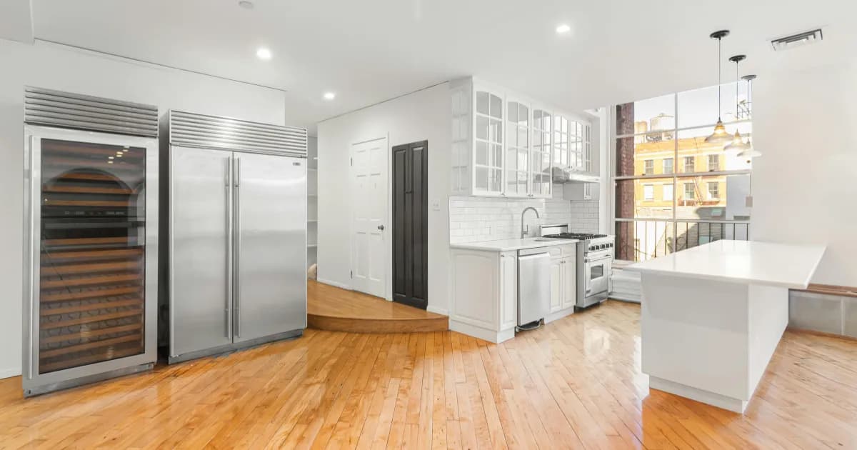 Modern, new kitchen with wood flooring and an open layout.