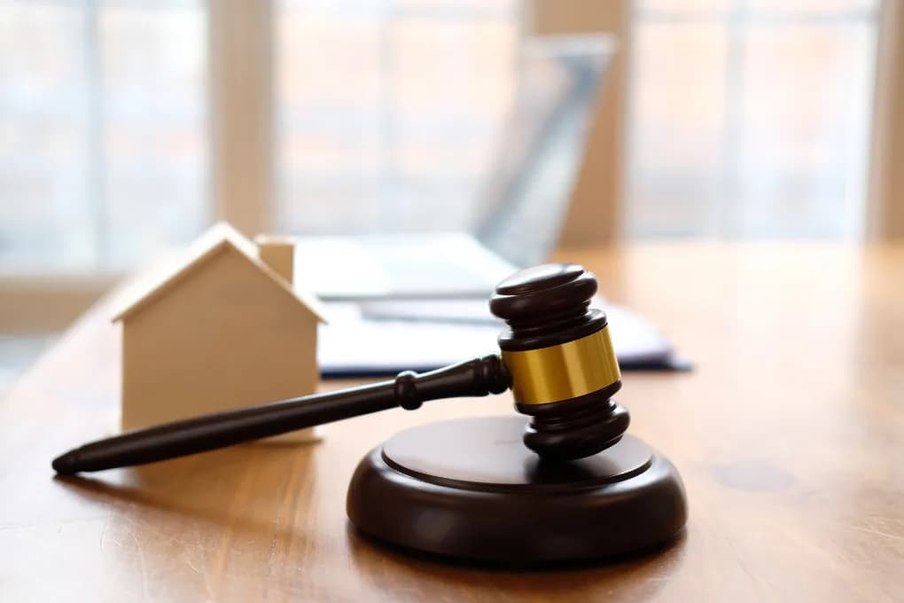image of wooden toy house and gavel