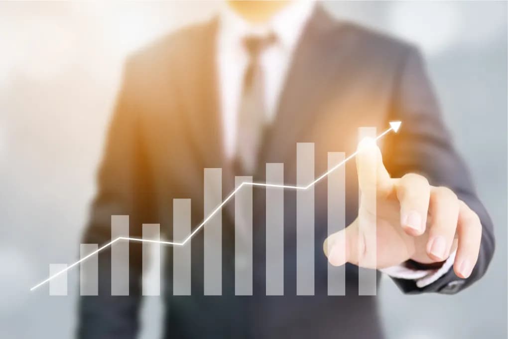 image of bars signaling growth with man in suit pointing to top