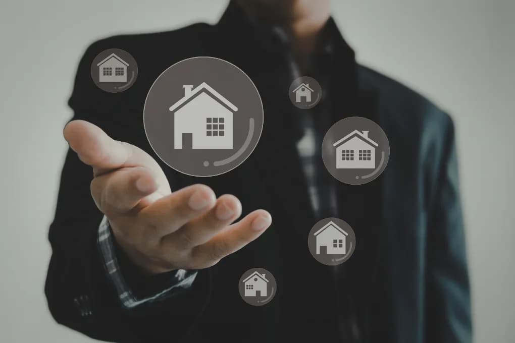 image of man in suit holding bubbles with house icons