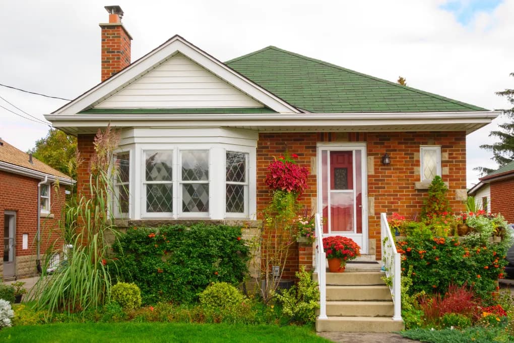 exterior image of brick home with plants outside