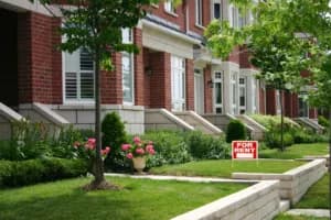 exterior image of houses on street with for rent sign