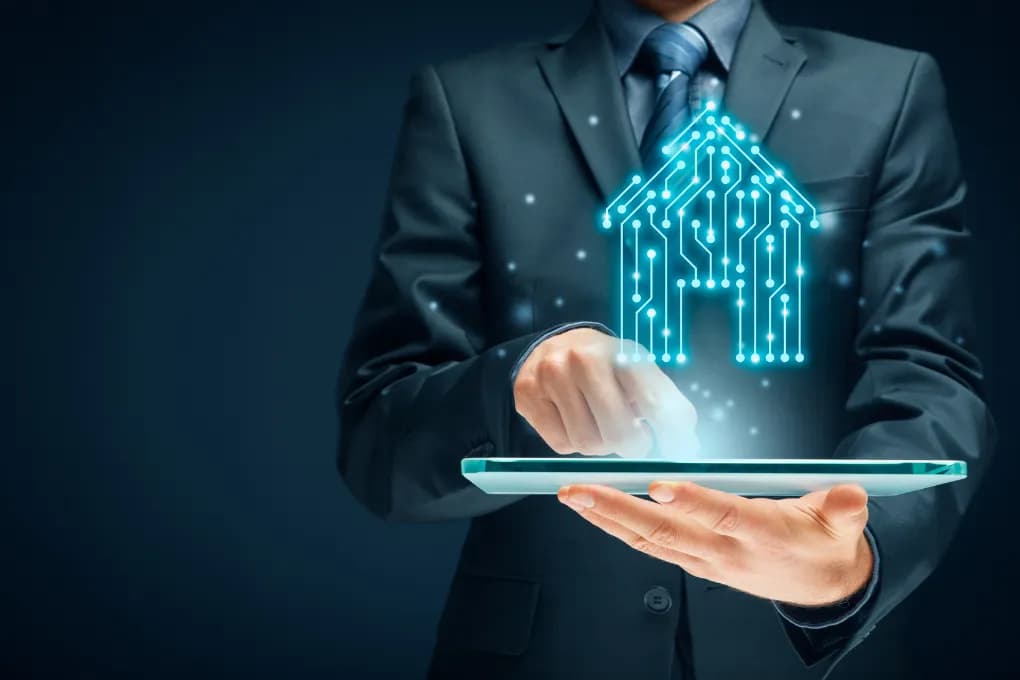 photo of man in suit with device projecting house hologram